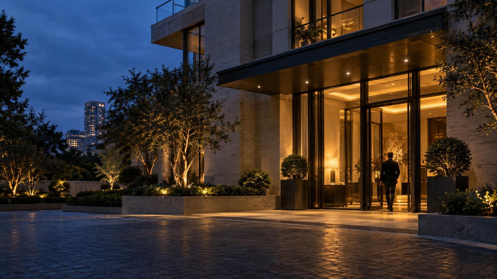 A contemporary residential entrance warmly illuminated at dusk